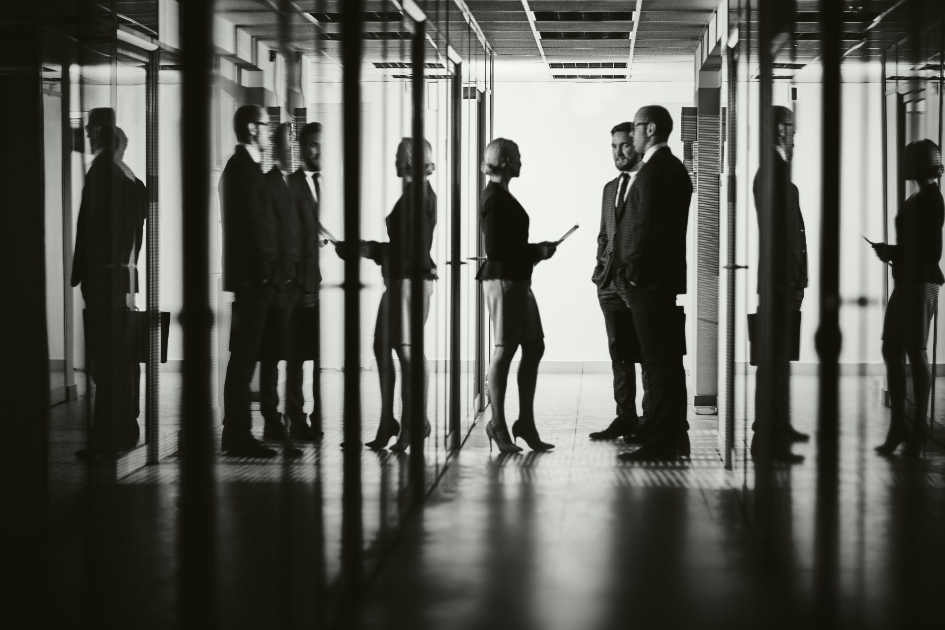Silhouettes of advisors meeting in a private office — the Market Capital Group approach to Bitcoin risk management